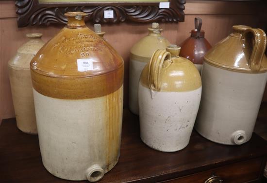 Seven Victorian and later stoneware flagons largest 50cm